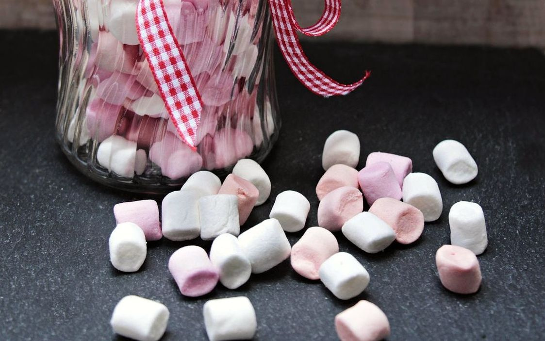 A stack of handmade gummy candies in a glass jar